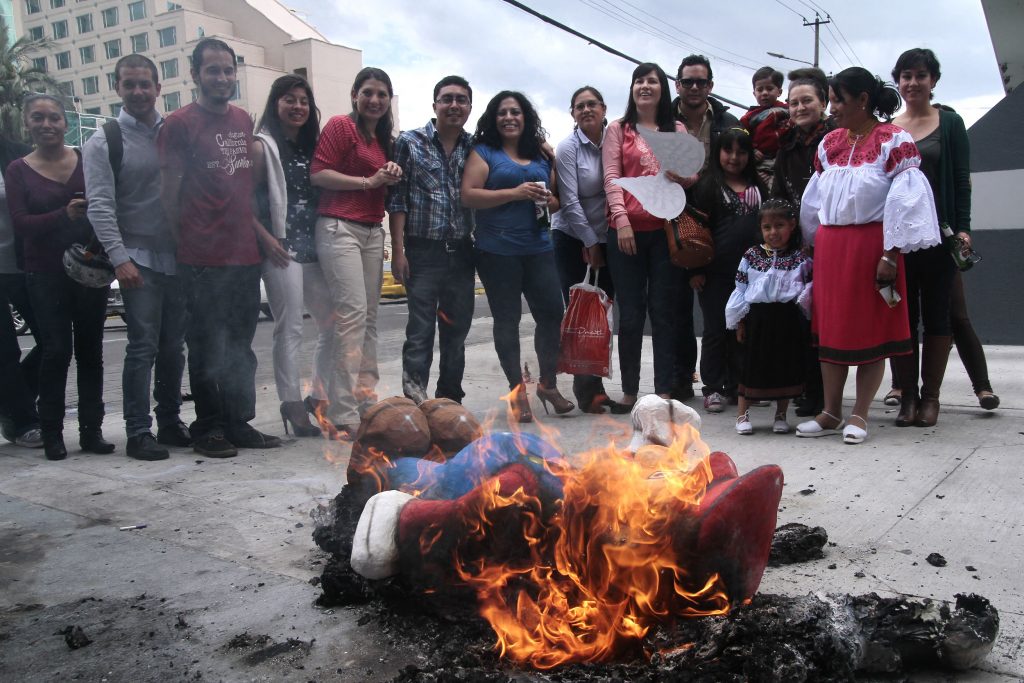 Emberek az ecuadori hagyományos újévi szokáson, amikor is hírességeket és népszerű karaktereket ábrázoló bábukat égetnek el abban a hitben, hogy ez szerencsét hoz a következő évre (Fotó: Juan Cevallos/AFP)