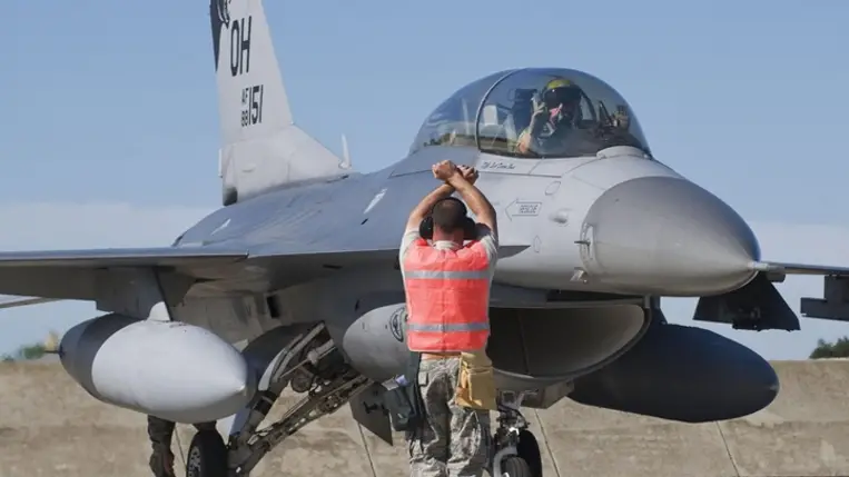 A repülésre felkészítés befejezését jelzi a személyzet egyik tagja egy amerikai F-16-os pilótájának. Fotó: MTI/Ujvári Sándor